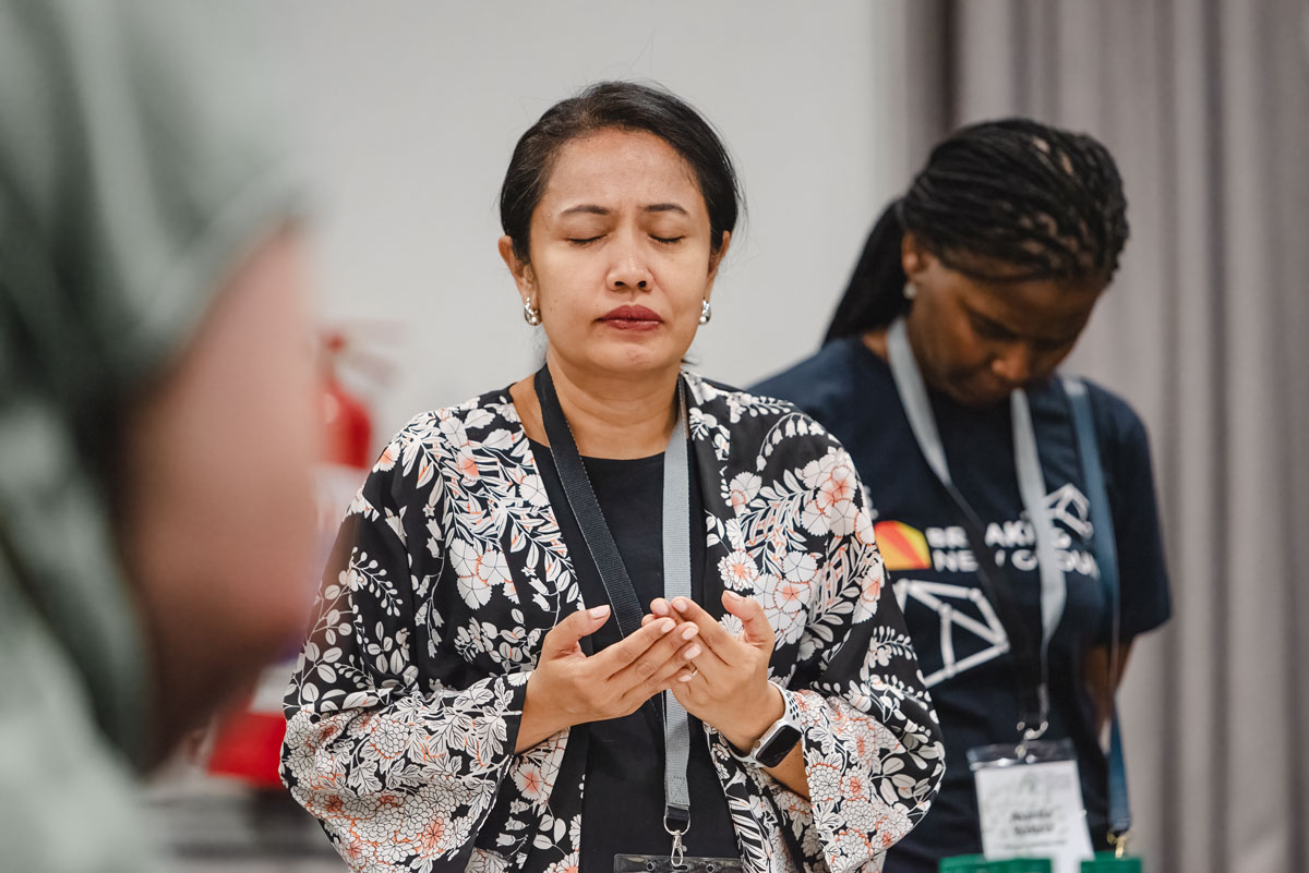 Woman praying with open hands.